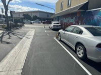 a white car is parked in a parking lot