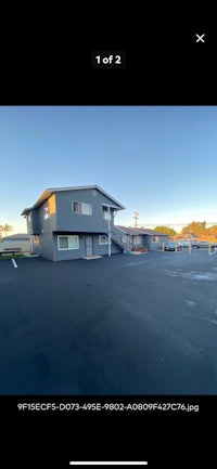 a photo of a parking lot with a building in the background