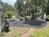 a driveway that has been paved with black asphalt