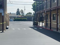 the parking lot of a motel with tape on it