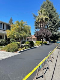 a street with a yellow tape in front of a house