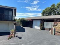 a house with two garages and a driveway