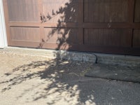 a garage door with a tree in front of it