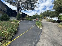 a house with a yellow tape on the side of the road