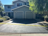 a driveway with a black tape in front of it