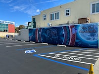 a parking lot with a mural painted on it