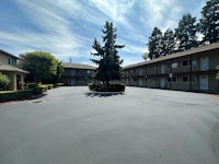 a parking lot in front of an apartment complex